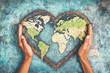 © vaivirga - Earth's day celebration, hands shaped heart with world map