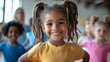 © A4719 - Happy Little Girl with Braids Smiling in Classroom