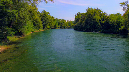 Wall Mural - Trezzo sul Adda, Italy. Aerial view of a mountain freshwater river with low water level surrounded by green trees. White swans on the river. Forest. Hydroelectric power station. Green planet. Ecology