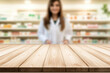© Konstiantyn Zapylaie - Wooden countertop in pharmacy with blurred pharmacist in background