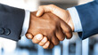 © Konstiantyn Zapylaie - Firm handshake sealing a business deal in a professional setting