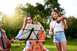 © peopleimages.com - Music, learning and child with violin in park for playing, practice and lesson with teacher. Cello, nature and woman teaching kids musical instruments for talent show, performance or recital