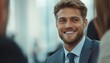 © Anastasiia - Successful young professional smiling during a business meeting in a modern office