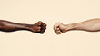 © Alexander - Two hands are clenched in fists, one black and one white. Concept of unity and strength, as the two hands come together in a fist