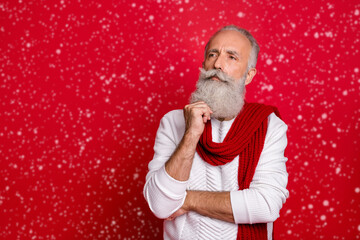 Portrait of his he nice attractive doubtful gray-haired man touching beard thinking creating decision isolated over bright vivid shine red background