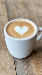 Sticker - A latte with heart-shaped foam art in a white cup on a wooden surface.