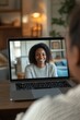 © felix_brönnimann - Smiling woman on video call with laptop, showcasing remote communication and personal connection in a cozy home setting.