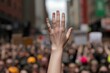 © Working Moments - Hand Raised in a Crowd, Close-up, Blurred Background, Protest, Demonstration, Crowd