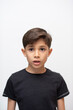 © Antonio Recena - 8-year-old boy looking at the camera in a simple and natural studio portrait with a white background