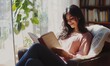 © Valentyna - Young 25s smiling Indian woman reading novel book relaxing alone on comfort armchair in cozy room, spend leisure enjoy favorite literature bought in bookshop. Booklover pastime at home, hobby