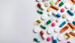 © Iryna - Multicolored capsules on white background. Blurred image. Assorted pharmaceutical medicine pills, tablets. Pills background. Banner for design. Vitamins and supplements background. Space for text