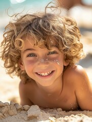 Canvas Print - A child smiles brightly while lying on the sand. AI.