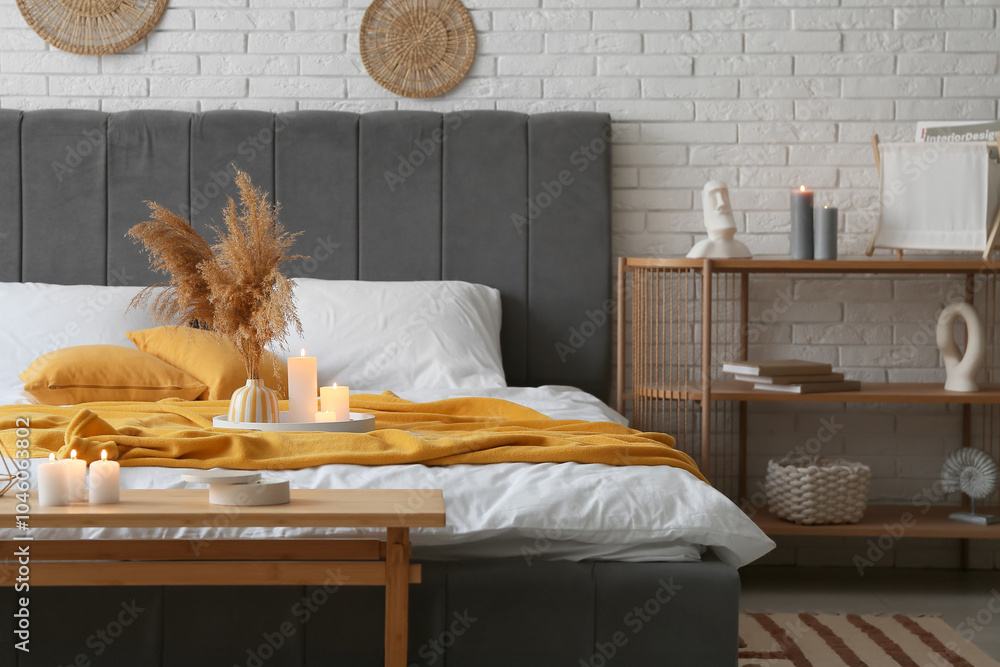 Interior of stylish bedroom with burning candles