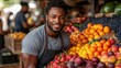 © hugy - A cheerful male vendor smiles amidst a display of fruits at a vibrant market