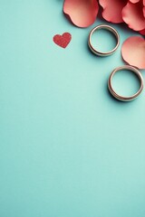 Wall Mural - Two wedding rings beside rose petals and a heart-shaped decoration.