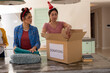 © Wavebreak Media - Christmas time, packing donations in box, multiracial female friends at home