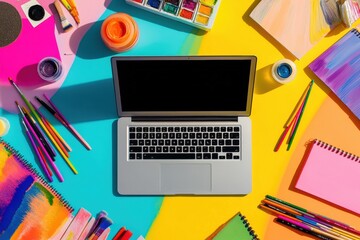 Poster - A vibrant workspace features a laptop at the center, surrounded by colorful art supplies and sketchbooks on a bright table. Generative AI