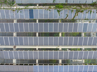 Wall Mural - aerial view directly above solar panels on the roof of a shopping mall building