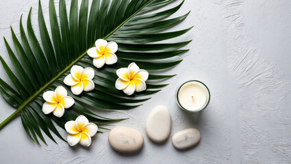 A serene spa setup featuring plumeria flowers, a palm leaf, smooth stones, and a candle, creating a peaceful ambiance perfect for relaxation and rejuvenation.