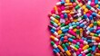 © Pluto - A vibrant array of colorful capsules and tablets spread across a pink backdrop, creating a visual representation of pharmaceutical possibilities.
