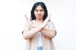 © M Alfan Setyawan - angry asian woman crossed arms showing stop gesture looks worry wearing casual clothes isolated on white background