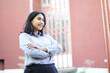 © M Alfan Setyawan - image of successful asian business woman standing over office building with cross hand wearing formal shirt, female entrepreneur smiling confident looking away show optimistic expression