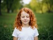 © Derek Brumby - Serene Young Girl with Curly Red Hair in a Sunny Park Setting