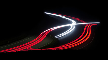 A curvy road illuminated by the light trails of vehicles at night, creating a winding path of red and white lights that highlight the fluidity and motion of the scene.