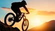 © Theraphol - Silhouette of a mountain biker descending at sunset.