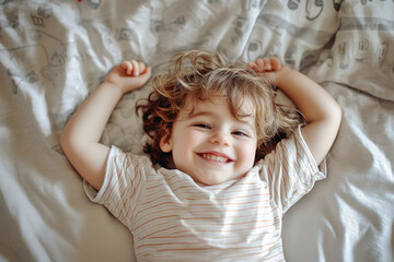 Little girl on bed, hair mid-air.