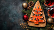 © Keitma - Board of Christmas tree shape smoked salmon toast on christmas eve dinner table to celebrate food and holidays