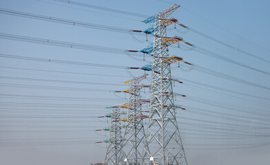 High voltage power line with bulding in thr background