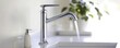 © ImagePulse - Installing a low-flow faucet in a contemporary kitchen, sleek and eco-friendly