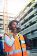 © peopleimages.com - Black woman, architect or civil engineer with speaker phone at site for communication or construction. Young African, builder or safety worker on mobile smartphone for radio or voice note in city