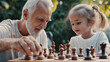 © Lizbond - Grandfather enjoys a game of chess with his young granddaughter in a sunny garden setting