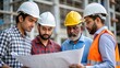 © N7 - Indian construction workers reviewing blueprints and discussing plans at a construction site.
