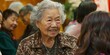 © KerXing - Honored Asian elder woman receiving recognition for her lifelong commitment