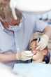 © peopleimages.com - Man, dentist and boy with tools for consultation, teeth whitening and oral inspection of dental hygiene. Mature, orthodontics and child with cleaning procedure, mouth assessment and braces treatment