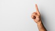 © Joachim - A close-up image of a hand with an extended index finger pointing upwards against a plain white background, conveying a message of attention or emphasis.