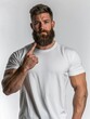 © DenisZ. - athletic man with beard pointing his finger at his beard, on white background