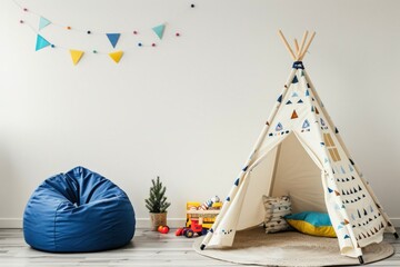 A white teepee tent with a colorful geometric pattern sits in a playroom with a blue beanbag chair. toys. a small potted plant. and colorful triangle garland on the wall