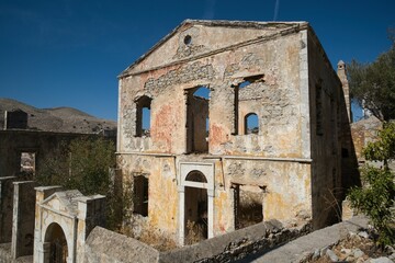 Wall Mural - Historic stone building ruin under blue sky.