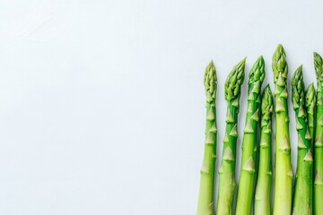 Wall Mural - Fresh green asparagus on clean white background
