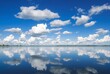 © Bogdan - _. Cloud Reflections in Lake Puffy white clouds drift in a blue