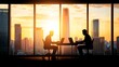 © Vibe Stock - Silhouetted professionals working against a sunset skyline