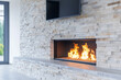 © Florian Dussart - A contemporary fireplace built into a sleek stone accent wall