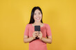 © apimook - Portrait of smiling Asian woman using a smartphone