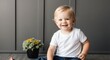 © Arceli - blonde toddler boy black background wearing plain white tshirt smiling happy portrait