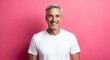 © Arceli - caucasian mature guy pink background wearing plain white tshirt smiling happy portrait
