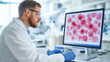 © Marketplace - A researcher in a lab coat analyzes red cell samples on a computer screen, showcasing advanced scientific research in a modern laboratory setting.